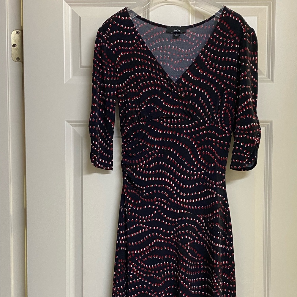 Beautiful cocktail dress by BCX. Black with red /white dots in a wave pattern.